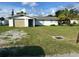 Ranch-style home with carport and mature landscaping at 3485 Roslyn Rd, Venice, FL 34293