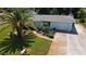 Attractive home with palm trees and a well-manicured lawn at 221 Malvern Dr, Venice, FL 34293