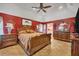 Spacious Primary bedroom with king-size bed and red walls at 2091 Marlin Way, Englewood, FL 34224