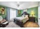 Spacious bedroom with a king-size bed, dark wood furniture, and plenty of natural light at 2091 Marlin Way, Englewood, FL 34224