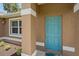 Teal front door with sidelights and landscaping at 5742 Janus Ave, North Port, FL 34288