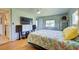 Bright bedroom with tropical bedding and wood flooring at 3364 Goldfinch Ln, Englewood, FL 34224