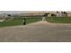 A person biking down a paved path, with buildings in the distance at 803 Harrington Lake N Dr # 75, Venice, FL 34293