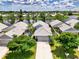 Aerial view showcasing the property and surrounding lake at 803 Harrington Lake N Dr # 75, Venice, FL 34293