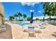 Community pool area with lounge chairs and seating at 803 Harrington Lake N Dr # 75, Venice, FL 34293