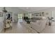 Spacious living room with neutral colored couches and a view of the backyard at 803 Harrington Lake N Dr # 75, Venice, FL 34293