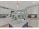 Bright kitchen boasts white cabinets, granite counters, and access to backyard at 803 Harrington Lake N Dr # 75, Venice, FL 34293
