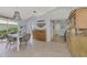 Dining area with French-style chairs and a view of the kitchen and hallway at 803 Harrington Lake N Dr # 75, Venice, FL 34293