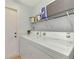 Functional laundry room with washer, dryer, and shelving at 803 Harrington Lake N Dr # 75, Venice, FL 34293