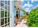 Outdoor patio with seating area adjacent to home at 803 Harrington Lake N Dr # 75, Venice, FL 34293
