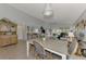 Dining area with a large table and chairs, and views of the living room and kitchen at 803 Harrington Lake N Dr # 75, Venice, FL 34293