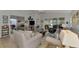 Living room with comfortable seating, large windows, and views of other rooms at 803 Harrington Lake N Dr # 75, Venice, FL 34293