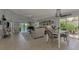 Open living area with tile floors, neutral furniture, and access to a patio at 803 Harrington Lake N Dr # 75, Venice, FL 34293