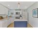 Updated kitchen featuring white cabinets, granite countertops, and a stylish island at 803 Harrington Lake N Dr # 75, Venice, FL 34293
