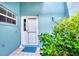 Inviting front door entrance with a teal accent wall at 803 Harrington Lake N Dr # 75, Venice, FL 34293