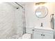Bathroom with a walk-in shower, white tile, and pebble floor at 4090 Pelican Shores Cir, Englewood, FL 34223