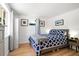 Bedroom with queen bed, light wood floors, and window at 4090 Pelican Shores Cir, Englewood, FL 34223