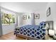 Cozy bedroom with a patterned duvet and ample natural light at 4090 Pelican Shores Cir, Englewood, FL 34223