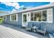 Gray deck with two chairs and side table at 4090 Pelican Shores Cir, Englewood, FL 34223