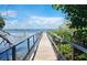 Wooden dock extending over calm waters at 4090 Pelican Shores Cir, Englewood, FL 34223