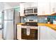 Modern kitchen with stainless steel appliances and wood countertops at 4090 Pelican Shores Cir, Englewood, FL 34223
