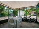 Screened porch with table, chairs and bicycle at 4090 Pelican Shores Cir, Englewood, FL 34223