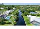 Aerial view of canal-front home with private pool and lush landscaping at 6 Cove Ln, Englewood, FL 34223