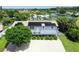 Aerial view of a canal-front home with solar panels and a large deck at 6 Cove Ln, Englewood, FL 34223