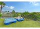 Backyard with two paddle boats and a view of the canal at 6 Cove Ln, Englewood, FL 34223