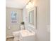 Simple half bathroom with toilet, sink and white vanity at 6 Cove Ln, Englewood, FL 34223