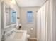 Clean bathroom, featuring a shower/tub combo, vanity with sink, and updated fixtures at 6 Cove Ln, Englewood, FL 34223