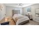 Bedroom with a gray upholstered bed and built-in desk at 6 Cove Ln, Englewood, FL 34223