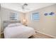 Bright bedroom with a double bed, window, and ceiling fan at 6 Cove Ln, Englewood, FL 34223