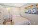 Small bedroom with double bed, closet, and wood-look floors at 6 Cove Ln, Englewood, FL 34223