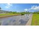 Expansive canal-front view with lush landscaping and a glimpse of neighboring homes at 6 Cove Ln, Englewood, FL 34223