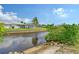 Tranquil waterfront view showcasing a canal and the home's backyard at 6 Cove Ln, Englewood, FL 34223