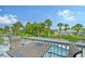 Deck with table and chairs overlooking canal and pool at 6 Cove Ln, Englewood, FL 34223
