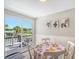 Bright dining area with patio access and pool view at 6 Cove Ln, Englewood, FL 34223