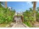Wooden dock leads to a peaceful canal, perfect for enjoying waterfront living at 6 Cove Ln, Englewood, FL 34223