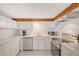 Modern kitchen with stainless steel appliances and white cabinetry at 6 Cove Ln, Englewood, FL 34223