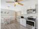 Eat-in kitchen with white cabinets and stainless steel appliances at 6 Cove Ln, Englewood, FL 34223