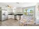 Updated kitchen with stainless steel appliances and white cabinets at 6 Cove Ln, Englewood, FL 34223