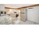 Eat-in kitchen featuring stainless steel appliances and white cabinets at 6 Cove Ln, Englewood, FL 34223