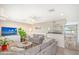 Spacious living room with two gray sofas, a coffee table, and a large TV at 6 Cove Ln, Englewood, FL 34223