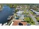 Aerial view showcasing house, pool, dock, and canal at 703 Portia N St, Nokomis, FL 34275