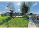 Spacious backyard with patio, dock access, and lush landscaping at 703 Portia N St, Nokomis, FL 34275