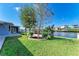 Landscaped backyard with pergola and water view at 703 Portia N St, Nokomis, FL 34275