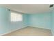 Light blue bedroom with tile floors and window with curtains at 703 Portia N St, Nokomis, FL 34275