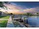 Wooden dock providing convenient water access at sunset at 703 Portia N St, Nokomis, FL 34275
