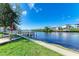 Waterfront view with a dock and picnic table at 703 Portia N St, Nokomis, FL 34275
